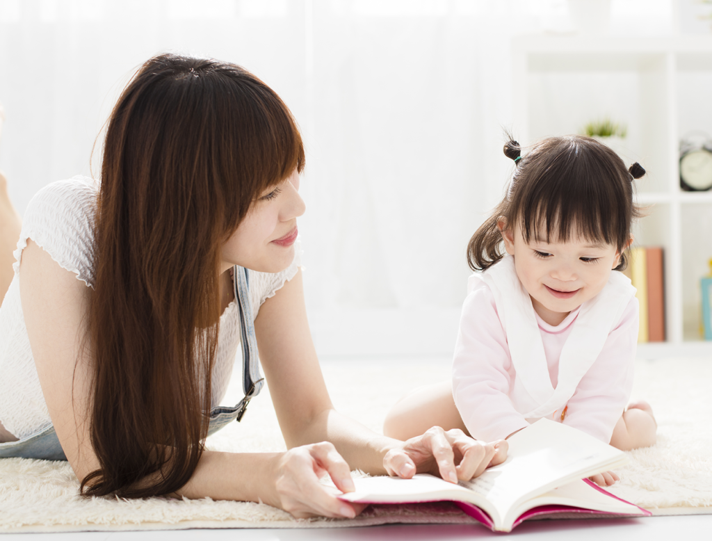 mother and young girl child reading 