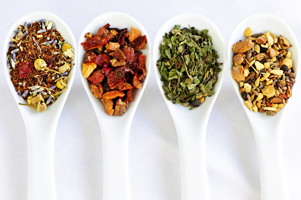 Assorted herbal wellness dry tea in spoons