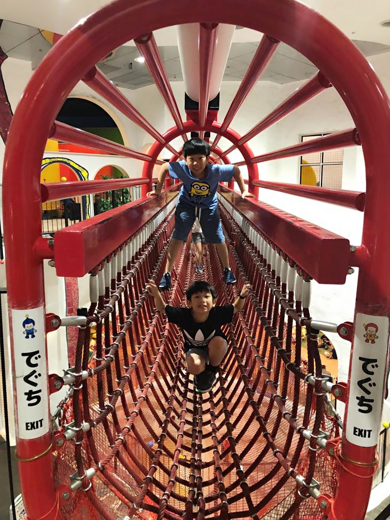 2 young boys on net bridge at Osaka Kids Plaza