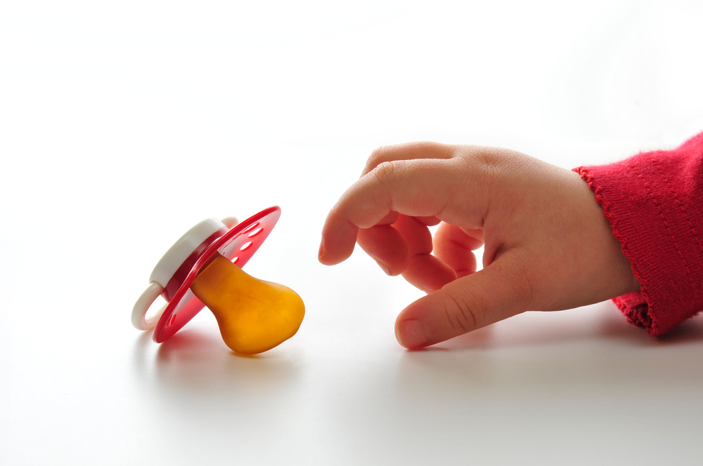 baby hand reaching out for pacifier