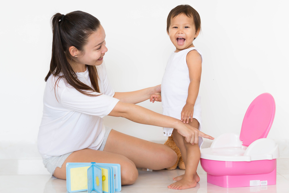 mother potty training young girl toddler