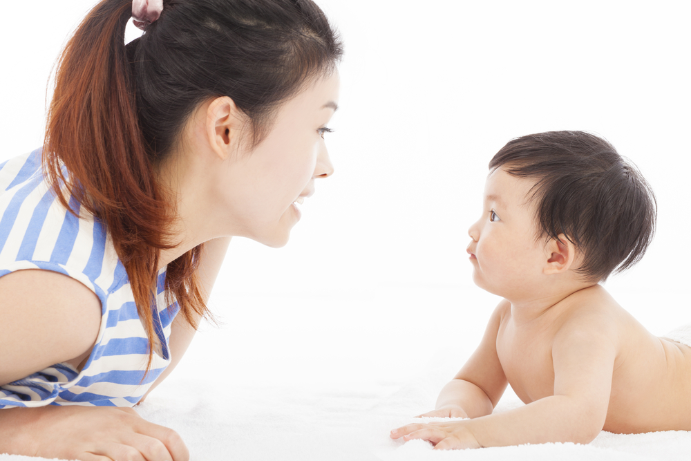 woman talking to baby toddler