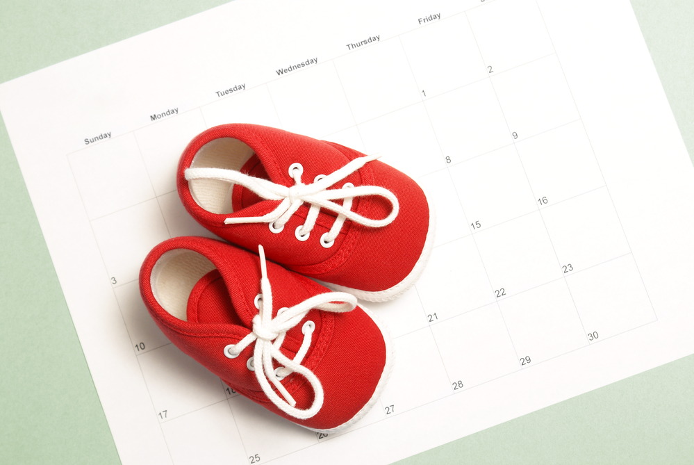 baby red shoe sneakers on paper calendar