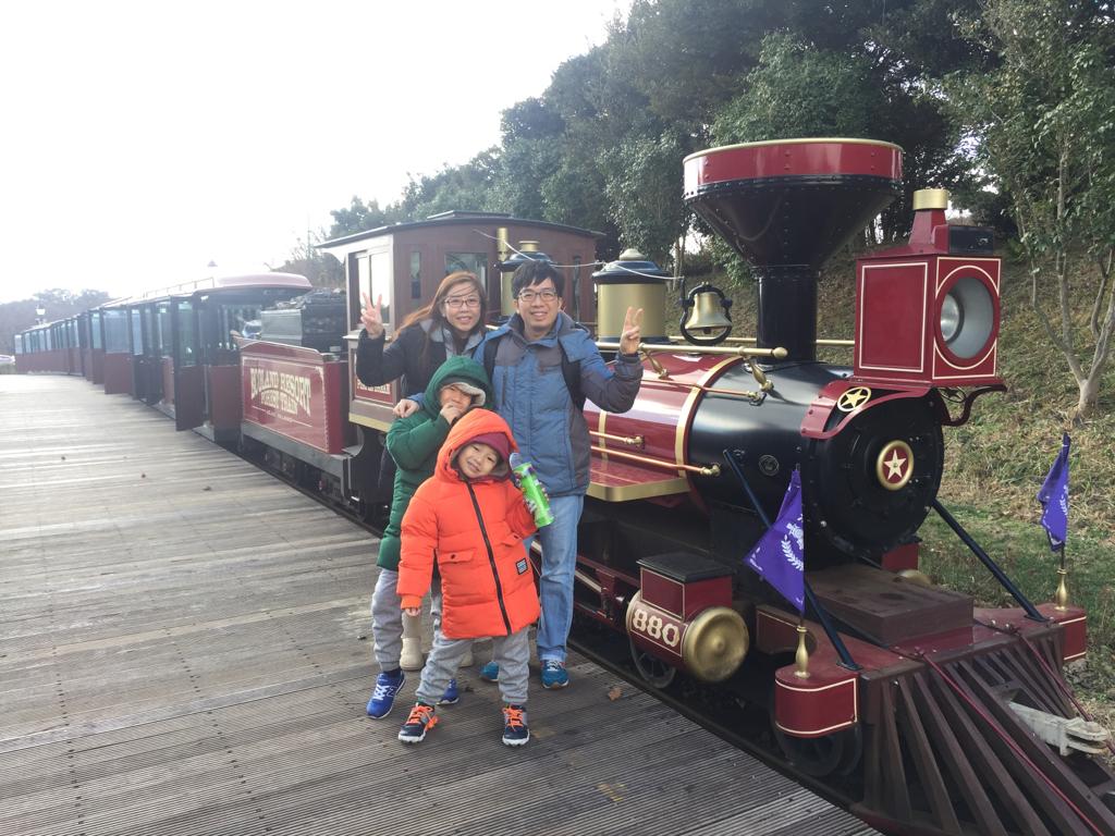 Family photo in front of Ecoland Jeju train